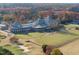 Aerial view of a clubhouse with golf course and driving range at 1309 Briar Patch Ln, Raleigh, NC 27615