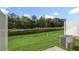 Fenced backyard with lush green grass, AC unit, and some trees at 1817 Hinesley Dr, Durham, NC 27703