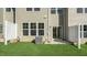 Backyard view featuring sliding glass door access, patio, and grassy area at 1817 Hinesley Dr, Durham, NC 27703