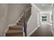 Carpeted staircase with dark wood railing leads upstairs at 1817 Hinesley Dr, Durham, NC 27703