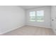 Bright bedroom with window and neutral decor at 1819 Hinesley Dr, Durham, NC 27703