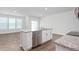 Modern kitchen with white cabinets, granite island, and stainless steel appliances at 1819 Hinesley Dr, Durham, NC 27703