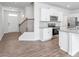Open concept kitchen with white cabinets, granite countertops, and stainless steel appliances at 1819 Hinesley Dr, Durham, NC 27703