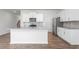 Open concept kitchen with white cabinets, granite island, and stainless steel appliances at 1819 Hinesley Dr, Durham, NC 27703