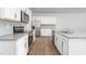 Modern kitchen featuring white cabinets, granite countertops, and stainless steel appliances at 1819 Hinesley Dr, Durham, NC 27703