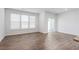 Sunlit living room with hardwood floors and sliding glass doors to patio at 1819 Hinesley Dr, Durham, NC 27703