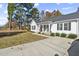 White house with black shutters, landscaping, and a driveway at 204 Burgess Cir, Broadway, NC 27505