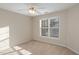 Bright bedroom with carpeted floor, ceiling fan, and large window at 3100 Lariat Ridge Dr, Wake Forest, NC 27587