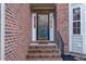 Brick front entryway with a glass door and brick steps at 3100 Lariat Ridge Dr, Wake Forest, NC 27587