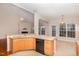 Kitchen with island, hardwood floors, and access to Gathering room at 3100 Lariat Ridge Dr, Wake Forest, NC 27587