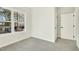 Well-lit bedroom featuring a window with a street view and carpeted floor at 406 Cherry St, Fuquay Varina, NC 27526