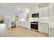 Modern kitchen with white shaker cabinets, quartz countertops, and stainless steel appliances at 406 Cherry St, Fuquay Varina, NC 27526