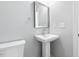 Small bathroom with pedestal sink and white toilet at 408 Cherry St, Fuquay Varina, NC 27526