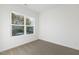 Well-lit bedroom with neutral carpeting and street view at 408 Cherry St, Fuquay Varina, NC 27526