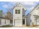 White two-story house with a garage and modern design at 408 Cherry St, Fuquay Varina, NC 27526