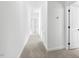 Hallway with carpet and access to bedrooms and stairs at 408 Cherry St, Fuquay Varina, NC 27526