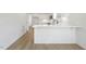 Modern kitchen island with white cabinets and quartz countertop at 408 Cherry St, Fuquay Varina, NC 27526