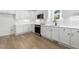 Modern kitchen with white cabinets and stainless steel appliances at 408 Cherry St, Fuquay Varina, NC 27526