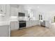 Modern kitchen with white cabinets and stainless steel appliances at 408 Cherry St, Fuquay Varina, NC 27526