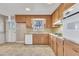 Bright kitchen with wood cabinets, gas range, and built-in oven at 503 Marshall Way, Durham, NC 27705