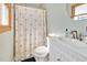 Clean bathroom with a shower/tub combo, vanity, and a window at 5515 Old Powell Rd, Holly Springs, NC 27540