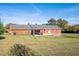 Brick house with pergola, patio, and fire pit at 5515 Old Powell Rd, Holly Springs, NC 27540