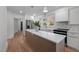 Modern kitchen with white cabinets, marble counters, and island at 5923 State Hwy 49, Burlington, NC 27215