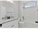 Modern bathroom with granite countertop, white vanity, and shower/tub combo at 652 Shawnee Dr, Louisburg, NC 27549