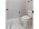 Simple toilet and sink bathroom with marble tile floor at 652 Shawnee Dr, Louisburg, NC 27549