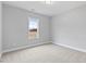Spacious bedroom with neutral carpeting and large window at 652 Shawnee Dr, Louisburg, NC 27549