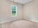Spacious bedroom with a window and carpet at 652 Shawnee Dr, Louisburg, NC 27549