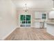 Bright dining area with hardwood floors and sliding glass doors to deck at 652 Shawnee Dr, Louisburg, NC 27549