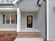 Front entry with brick steps and a black front door at 652 Shawnee Dr, Louisburg, NC 27549