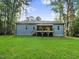 Back of house with deck and large backyard at 652 Shawnee Dr, Louisburg, NC 27549