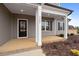 Front porch with black front door and white columns at 652 Shawnee Dr, Louisburg, NC 27549