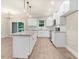 Open concept kitchen with white cabinets, granite counters, and island at 652 Shawnee Dr, Louisburg, NC 27549