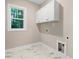 Laundry room with upper cabinets and a window at 652 Shawnee Dr, Louisburg, NC 27549