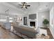 Open living room featuring a fireplace, hardwood floors, and lots of natural light at 652 Shawnee Dr, Louisburg, NC 27549