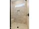 Walk-in shower with tiled walls and built-in bench seating at 652 Shawnee Dr, Louisburg, NC 27549