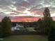 Stunning sunset view of house and neighborhood at 7217 Blannie Farms Ln, Willow Springs, NC 27592