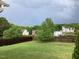 Large backyard with green grass, privacy fence, and rainbow at 7217 Blannie Farms Ln, Willow Springs, NC 27592