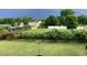 Backyard with green grass, trees, and a glimpse of a pool at 7217 Blannie Farms Ln, Willow Springs, NC 27592