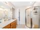 Main bathroom with shower, vanity, and linen closet at 7217 Blannie Farms Ln, Willow Springs, NC 27592