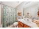 Clean bathroom with shower/tub combo and wood vanity at 7217 Blannie Farms Ln, Willow Springs, NC 27592