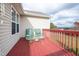 Red deck with two chairs and small table, overlooking backyard at 7217 Blannie Farms Ln, Willow Springs, NC 27592