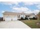 Two-car garage and well-manicured lawn at 7217 Blannie Farms Ln, Willow Springs, NC 27592