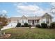Beige house with two-car garage and landscaping at 7217 Blannie Farms Ln, Willow Springs, NC 27592