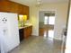 Bright kitchen with refrigerator, dishwasher, and view to dining area at 7217 Blannie Farms Ln, Willow Springs, NC 27592
