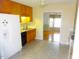 Kitchen with wood cabinets, refrigerator, and view to dining room at 7217 Blannie Farms Ln, Willow Springs, NC 27592