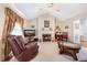 Cozy living room featuring a fireplace, comfy seating, and a ceiling fan at 7217 Blannie Farms Ln, Willow Springs, NC 27592